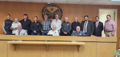 Commissioners Present 50th Anniversary Commendation to Railey Realty, Inc. Photo (standing l-r): Jimmy Railey, Sis Railey, Russell Bounds, Mike Kennedy, Jon Bell, Kevin Liller, Bill Weissgerber, Rich Orr, Connor Norman, Nick Sharps, ,and Steve Kelley. Photo (sitting l-r): Commissioners Paul Edwards, Larry Tichnell, and Ryan Savage.