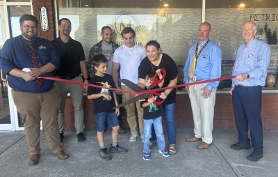 The ribbon is cut at Moonglade Integrative LLC. Photo (l-r): Front - Gunnar Resh, Sterling Resh and Jen Resh. Back - Business Development Specialist Connor Norman, Ron Bittinger, Jared Resh, Riley Upole, Commissioner Paul Edwards, and Chamber President Andrew Fike.