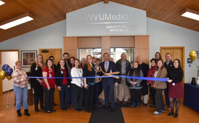 Men and women at a ribbon cutting ceremony celebrating GRMC's newly renovated Health & Wellness Center.