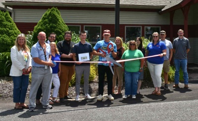 Men and women celebrating the ribbon cutting for Deep Clean Detailers