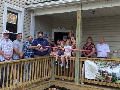 Officials from the Town of Friendsville, Garrett County Business Development, and the Garrett County Chamber of Commerce are pictured celebrating the ribbon cutting with the Donahue Family. Photo generously provided by Carol McMahon Calhoun, All Earth Eco Tours.