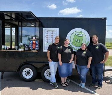 Photo credit: Claire Sullivan, The Republican News. The Sodalightful crew is pictured in front of their trailer in the Grantsville Plaza.