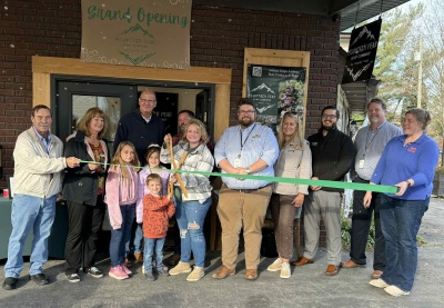 Men and women celebrating the ribbon cutting for Mountain Peak Soap Company
