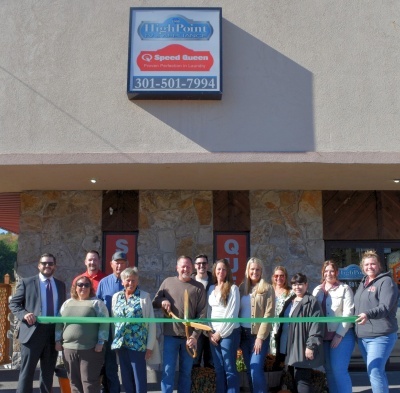 Men and women celebrating the ribbon cutting for HighPoint TV & Appliance.