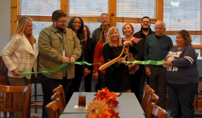 Men and women celebrating the ribbon cutting for Kim Carter Life Coaching.