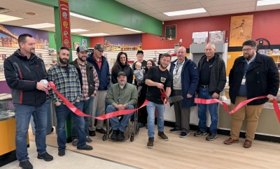 Local dignitaries join owner Casey Kamp, along with his family and staff, for The Pharm’s ribbon cutting ceremony in Grantsville, MD